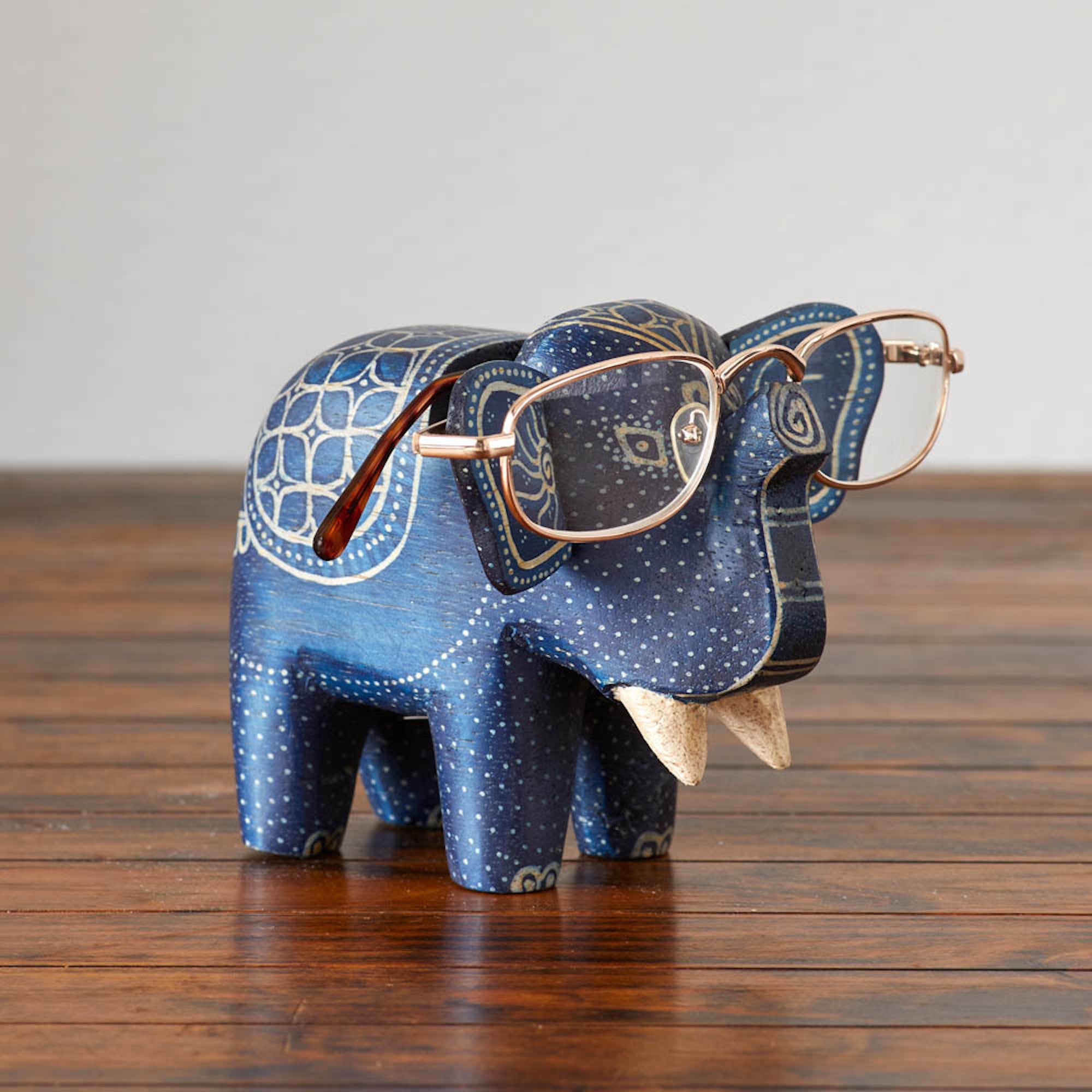 Hand-carved wooden elephant eyeglass holder used for stylish organization.