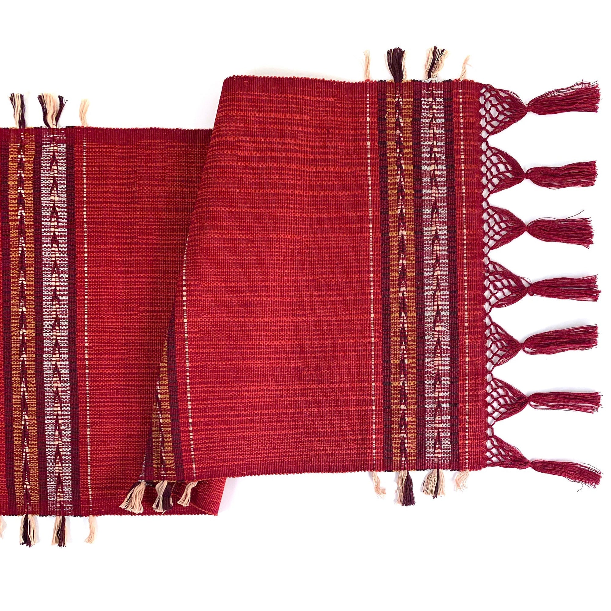 Handwoven indigo table runner styled on a wooden kitchen table, adding texture and warmth to artisan kitchen decor.