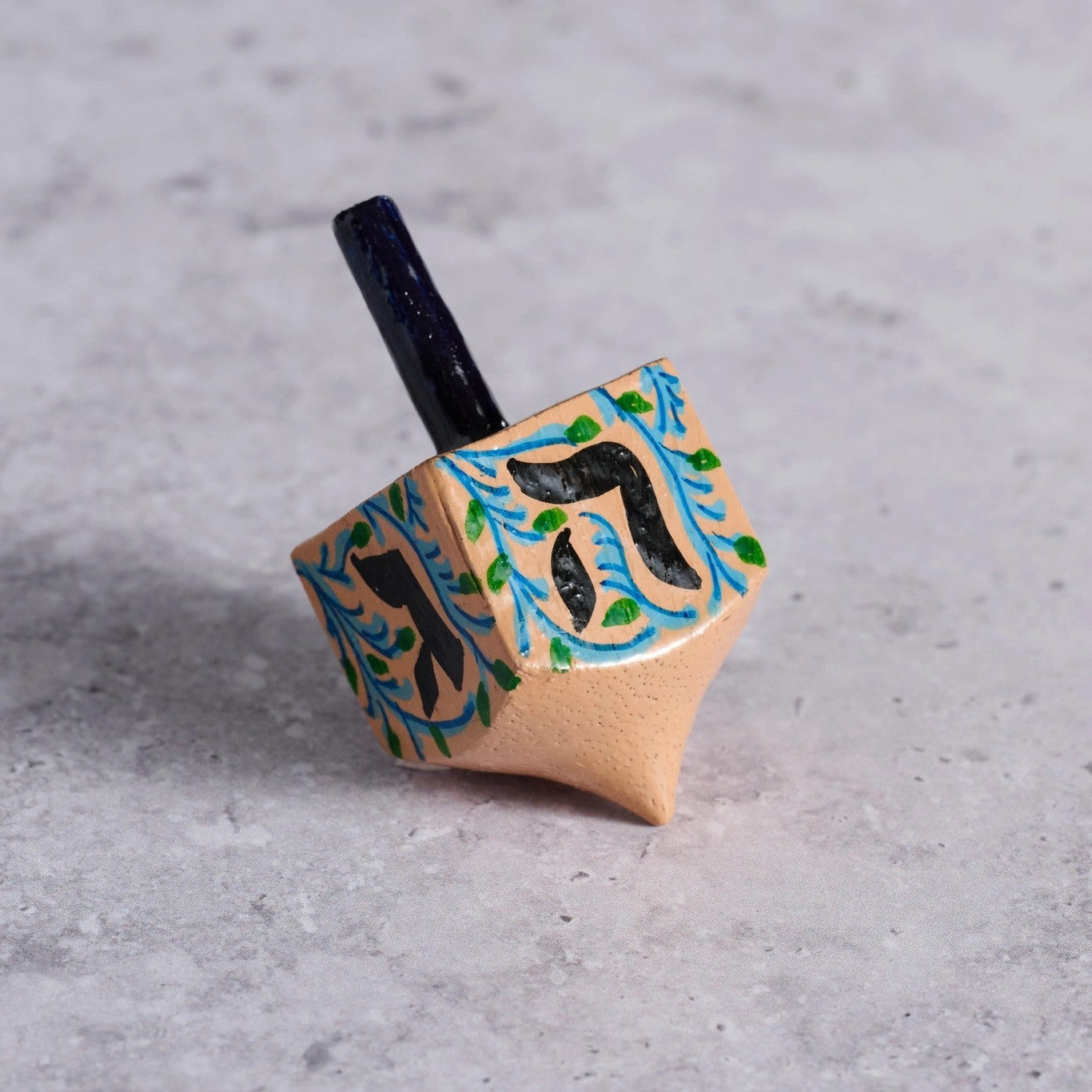 Handpainted wooden dreidel with Hebrew letters
