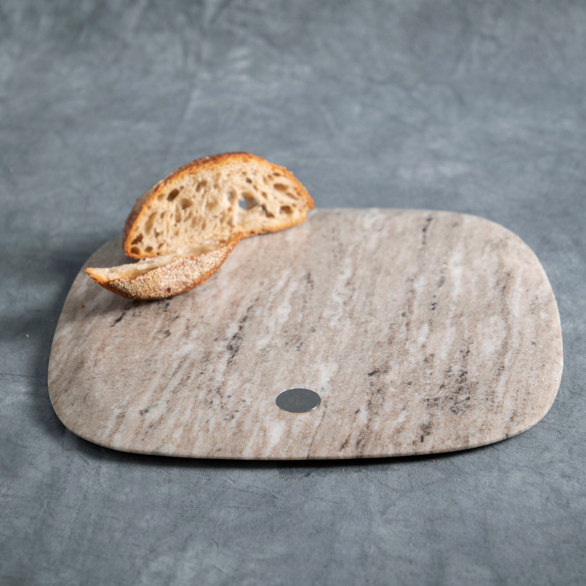 Marble serving board with bread on top - platters & serving board collection at Better World Bio