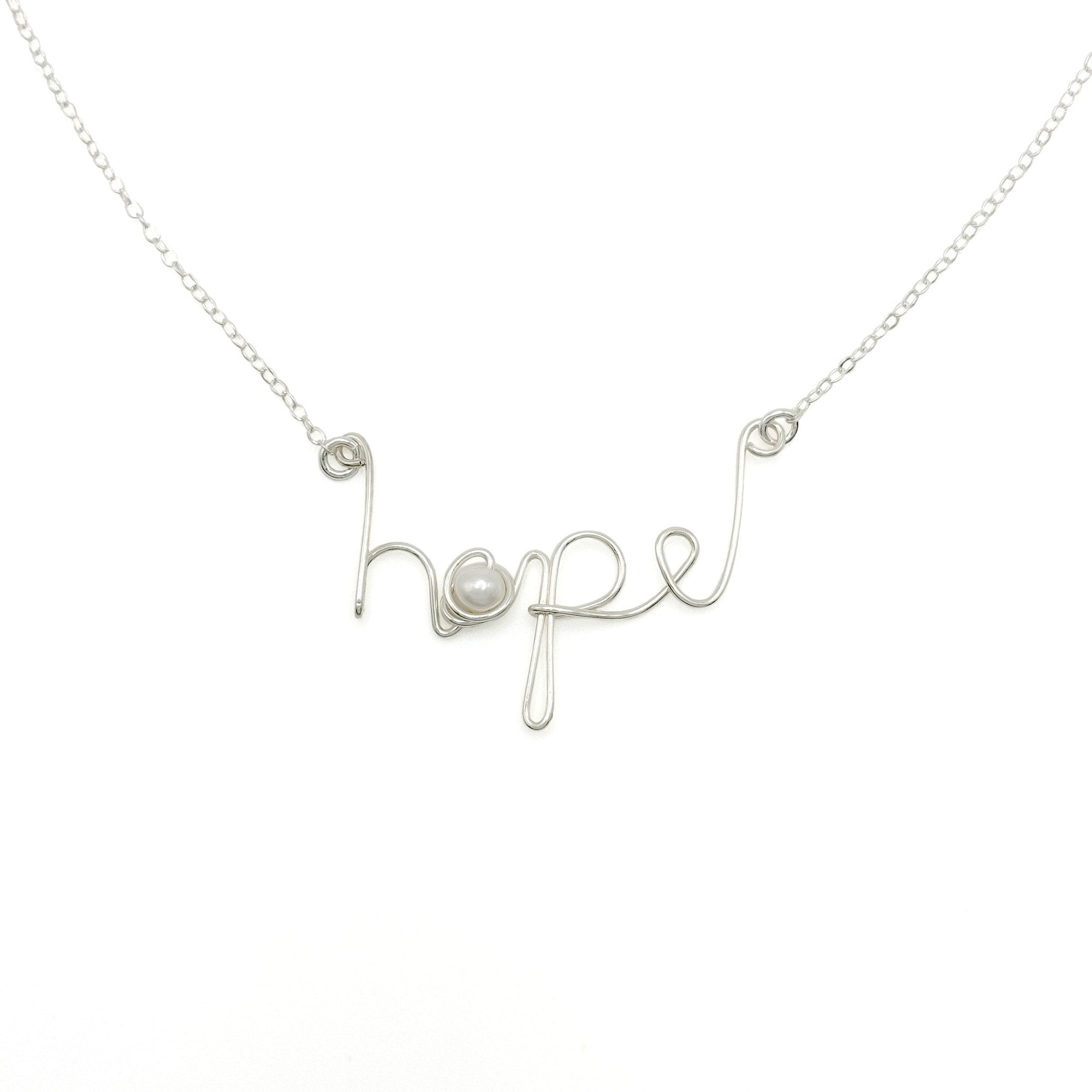 Sterling silver necklace with the word “hope” in delicate script, a meaningful and minimalist jewelry piece.