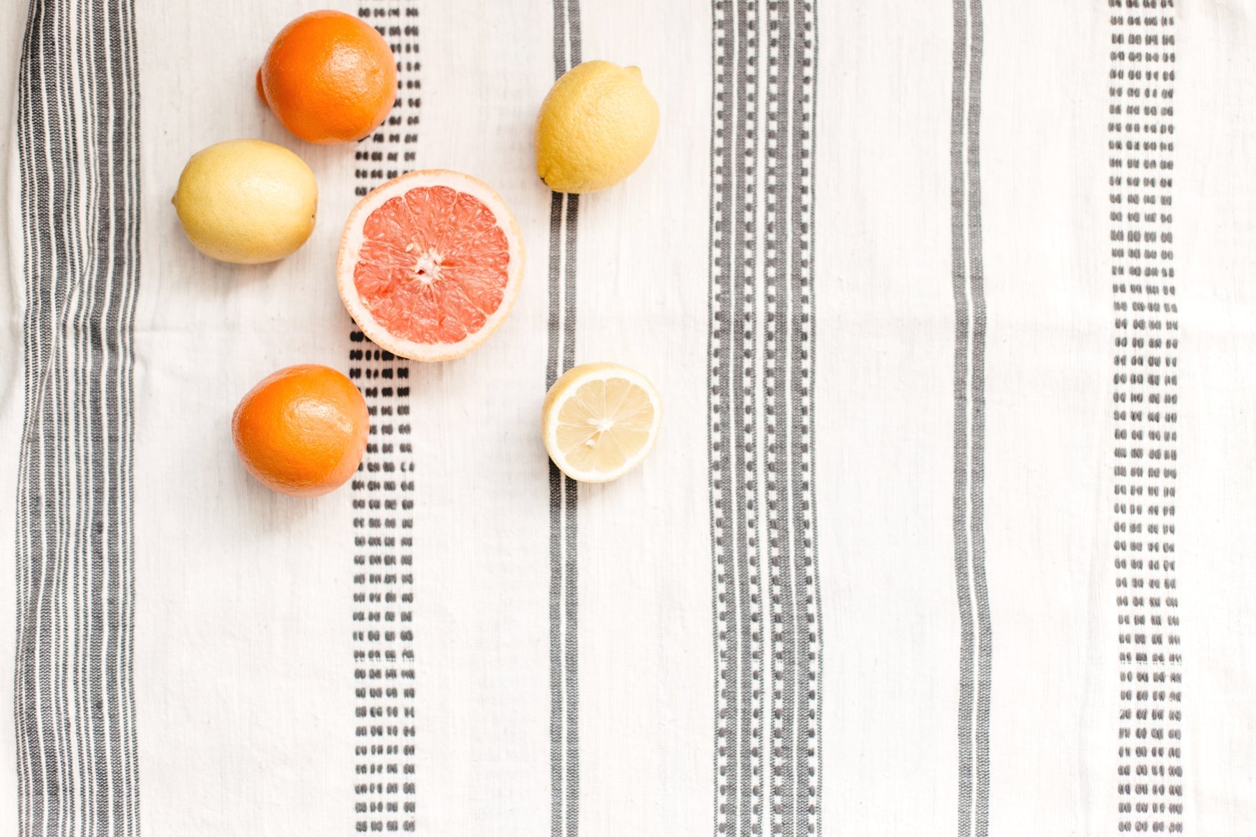 White and gray tablecloth with fruit on top - tablecloth collection at Better World Bio