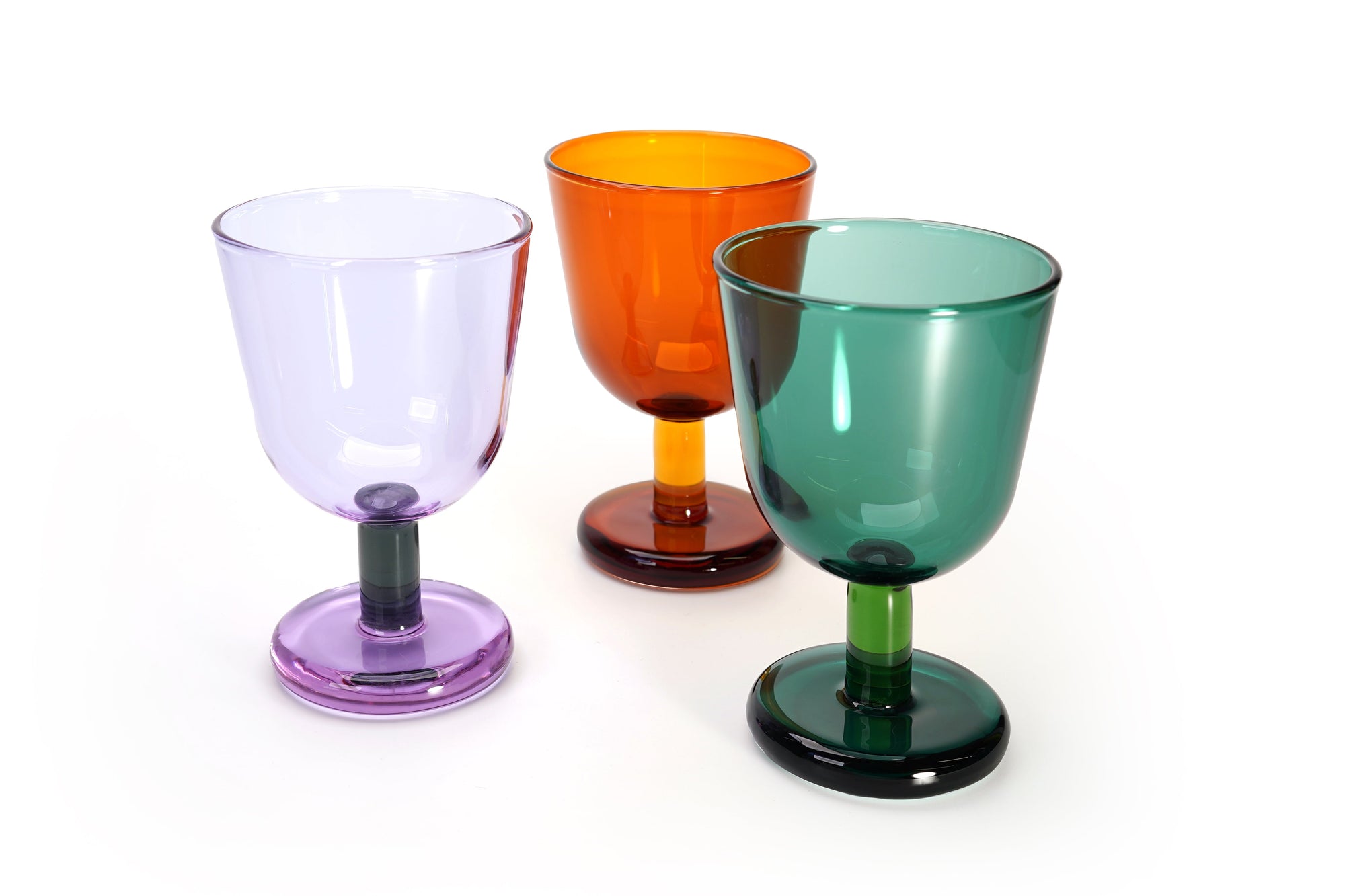 Three colorful glass goblets on a white background
