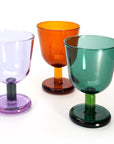 Three colorful glass goblets on a white background