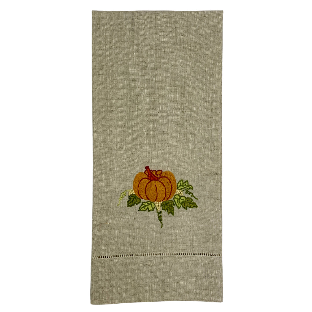 Textured towel with embroidered pumpkin design on a white background