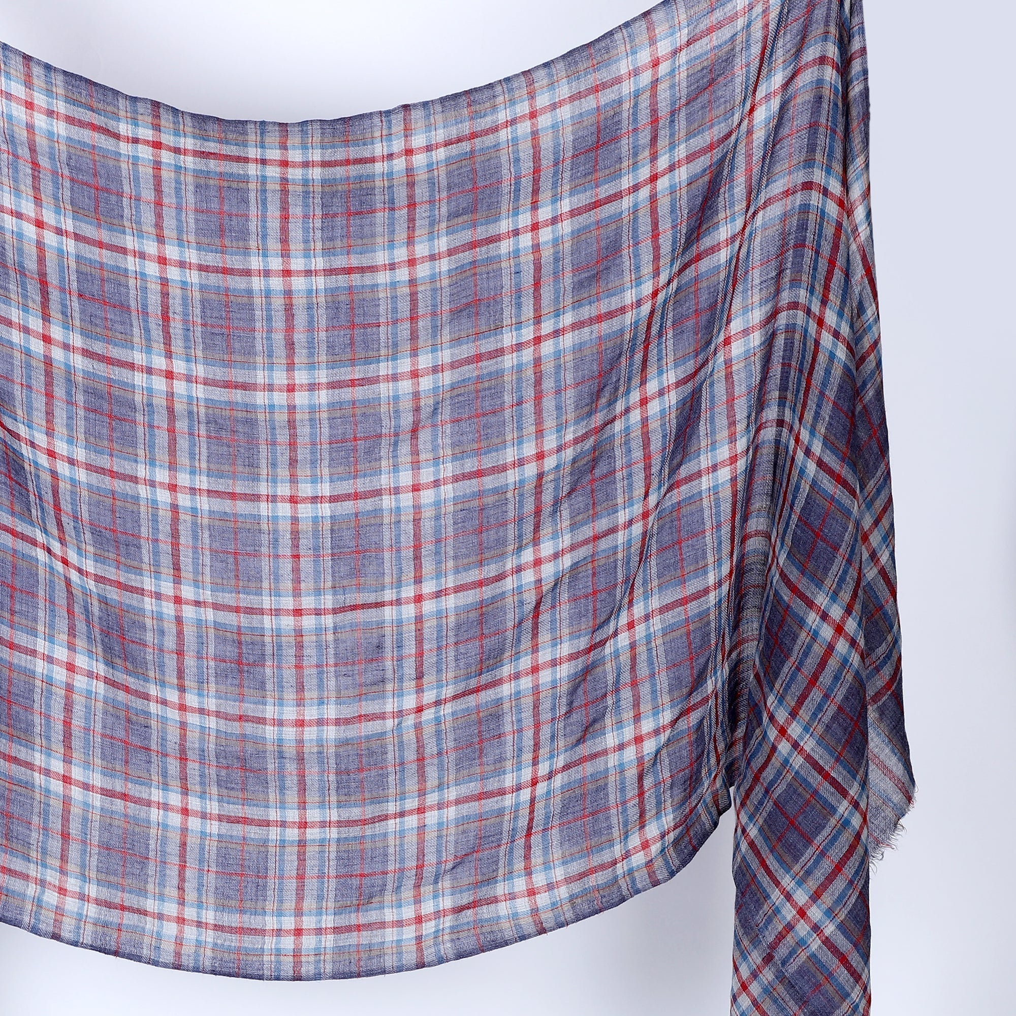 Plaid wool scarf with red, blue, and white pattern on a white background