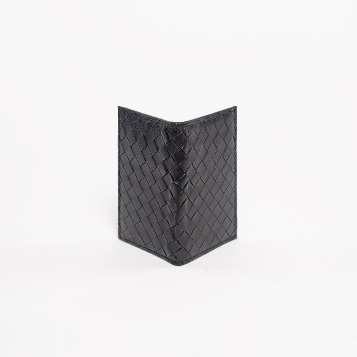 Black woven wallet on a white background