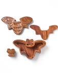 Set of wooden animal-shaped cookie cutters on a white background