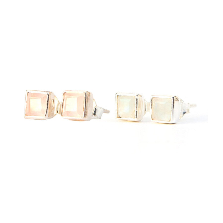 Pair of gold square stud earrings on a white background