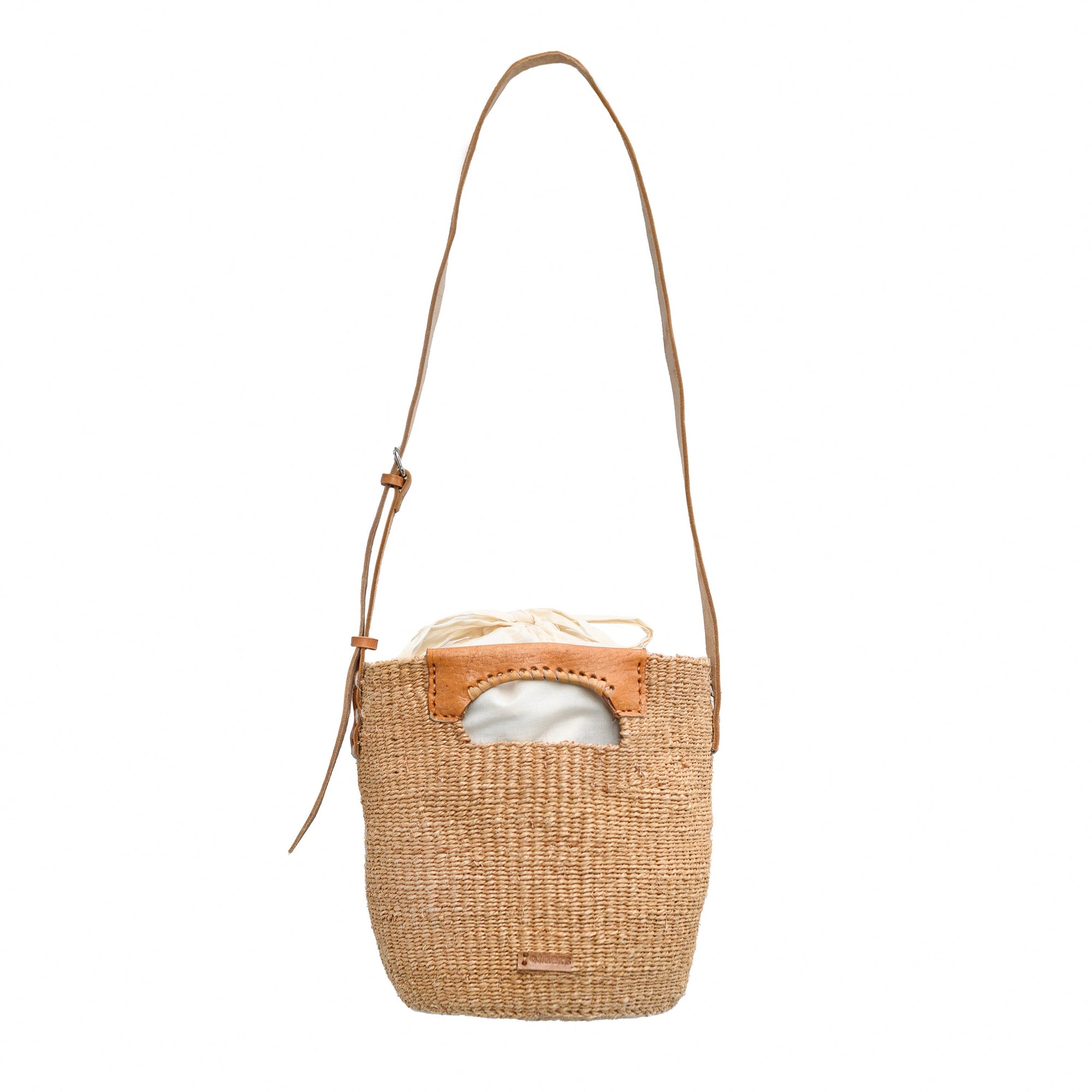 Woven handbag with leather strap on a white background