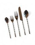 Set of silver cutlery with twisted handles on a white background