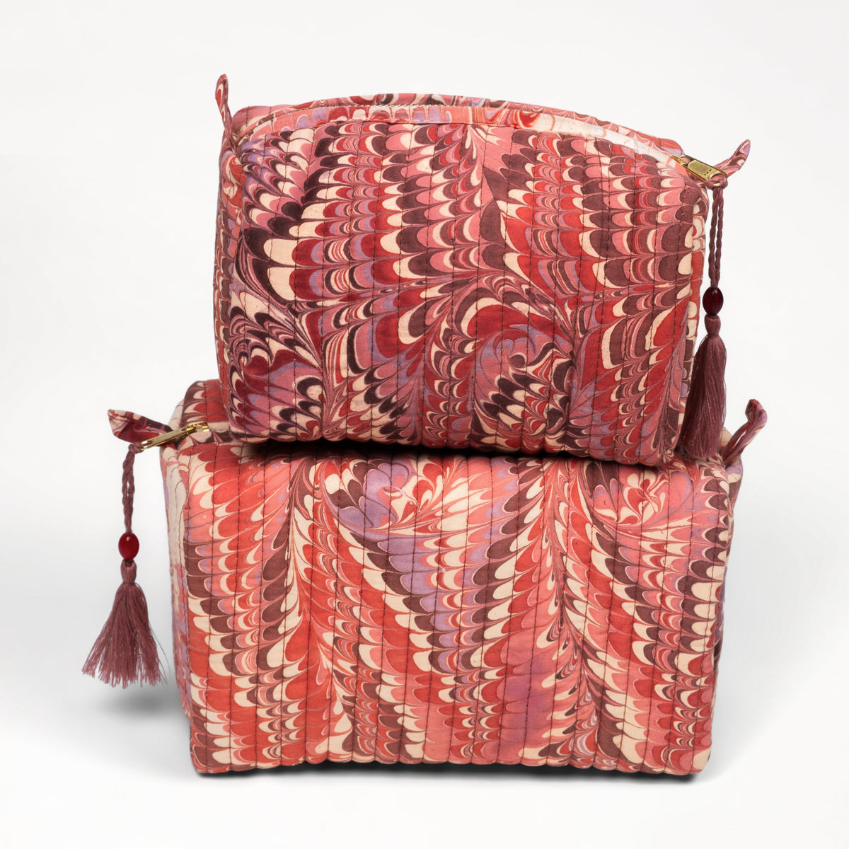 Two red patterned bags stacked on a white background