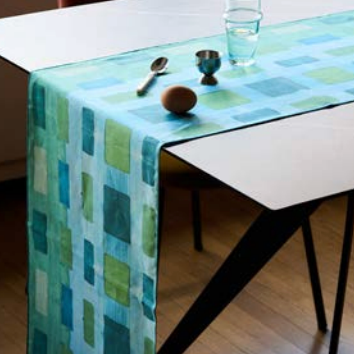 Blue table runner with a geometric pattern on a table