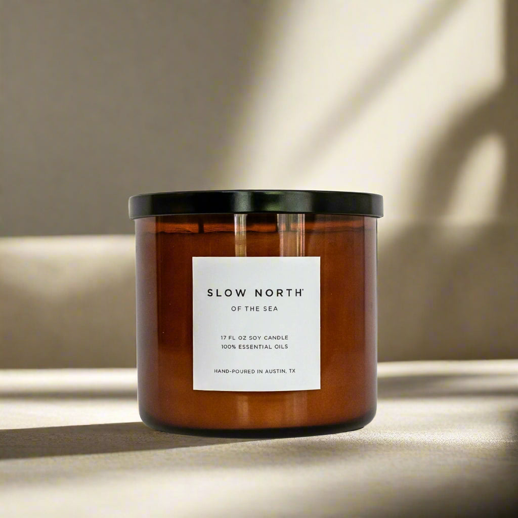 Candle with 'Slow North of the Sea' label on a neutral background