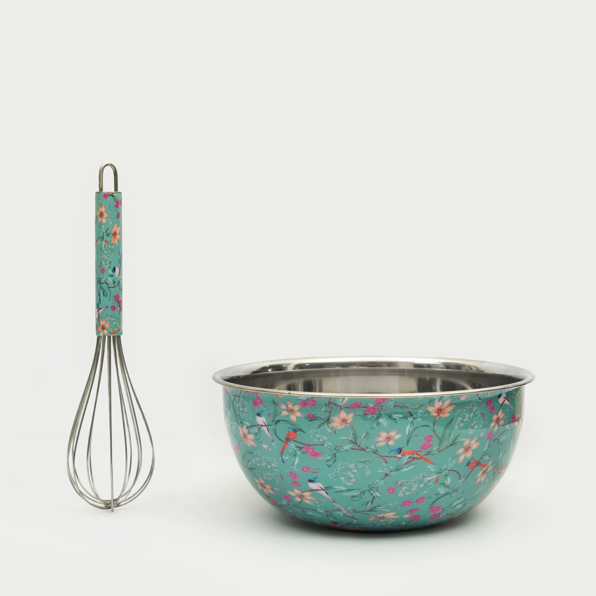 Floral-patterned mixing bowl and whisk on a white background