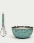 Floral-patterned mixing bowl and whisk on a white background