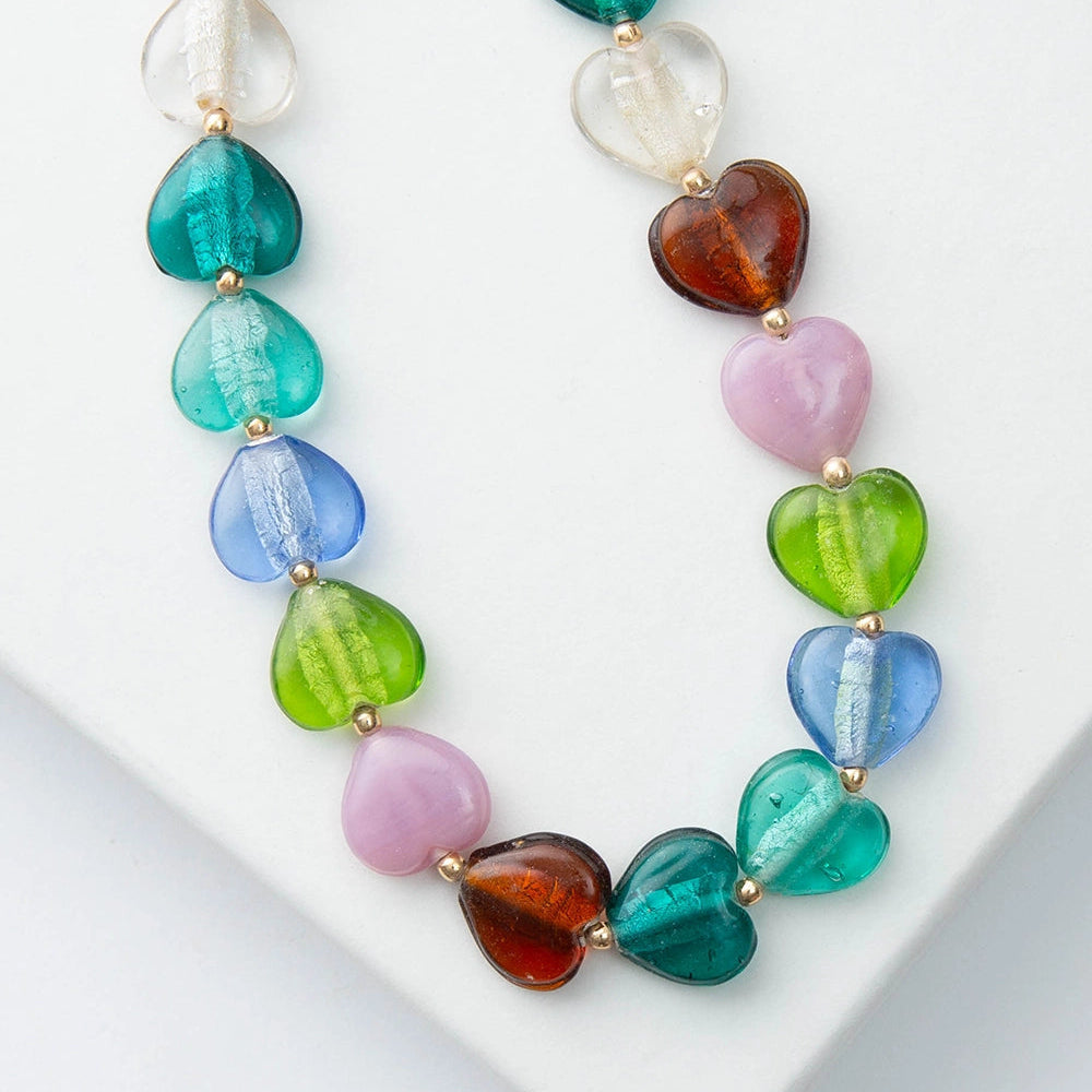 Necklace with multicolored heart-shaped beads on a white surface