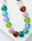 Necklace with multicolored heart-shaped beads on a white surface