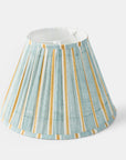 Striped lampshade with green and yellow pattern on a white background.