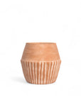 Terracotta pot with ribbed texture on a white background