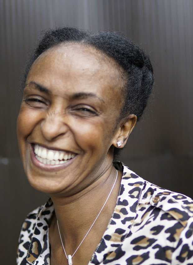 Woman wearing a leopard print top with a neutral background