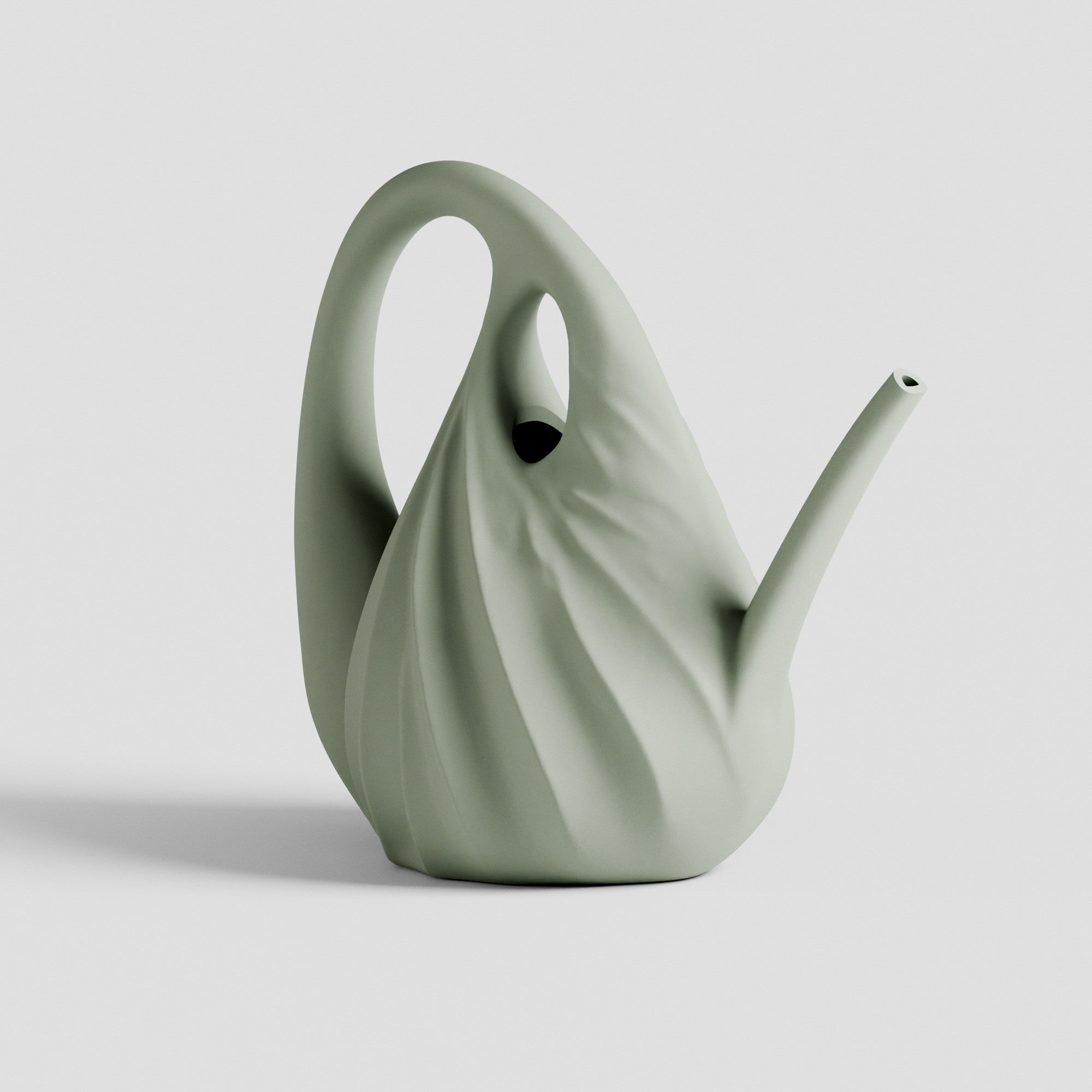 Green ceramic watering can on a light gray background