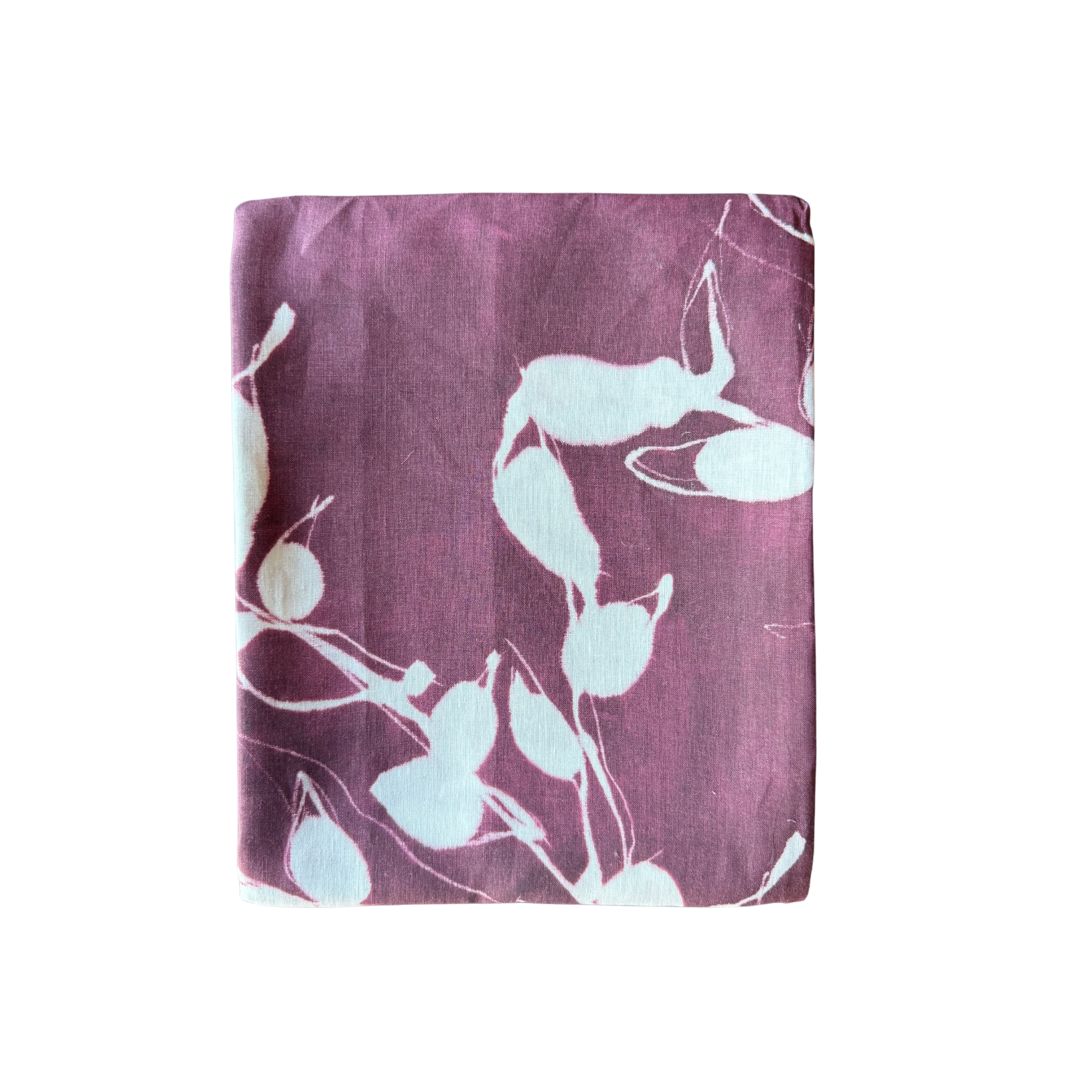 Folded tablecloth with light blue floral pattern on a purple background