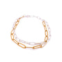 Two chain necklaces, one gold and one silver, on a white background