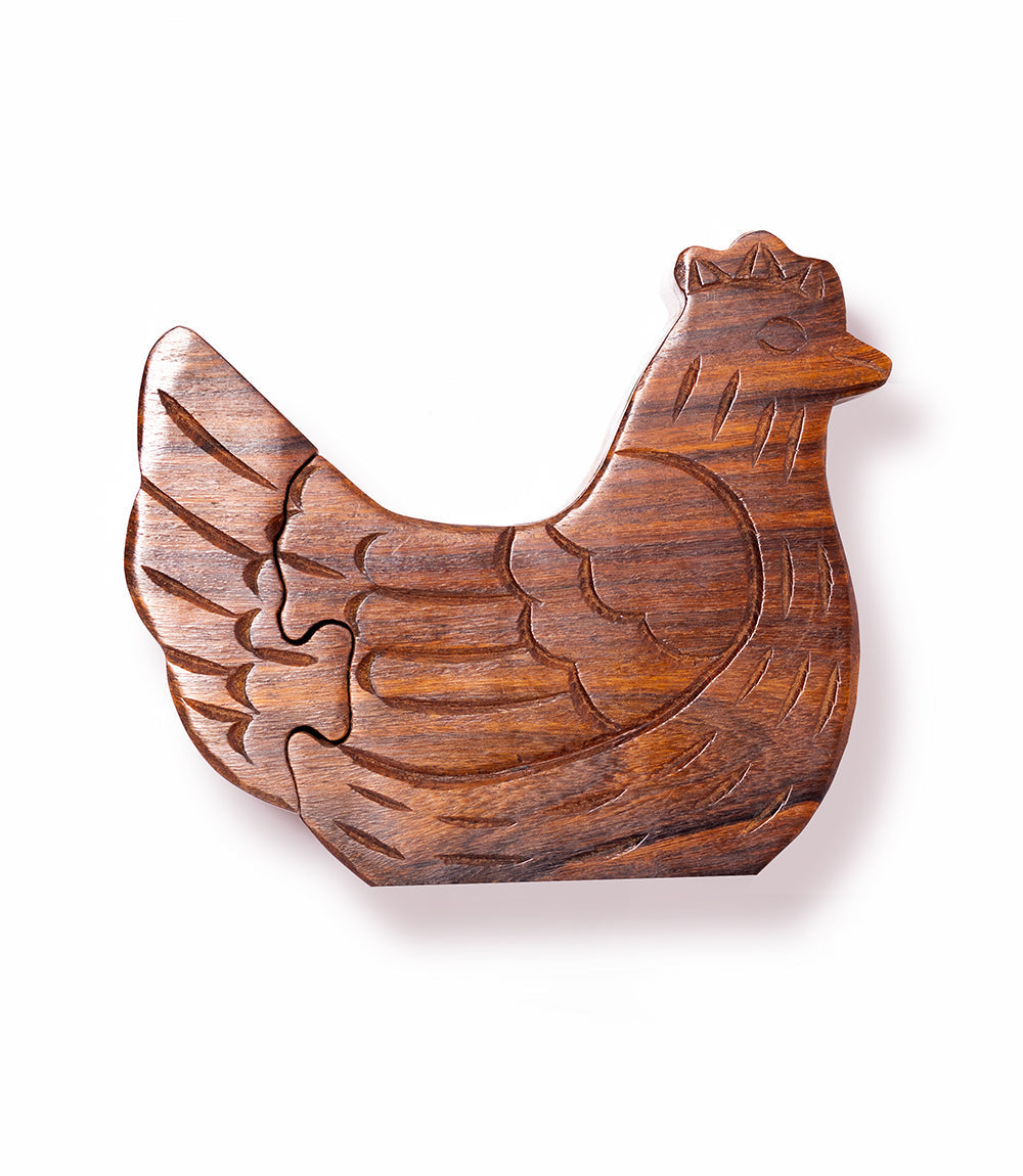 Wooden puzzle shaped like a chicken on a white background
