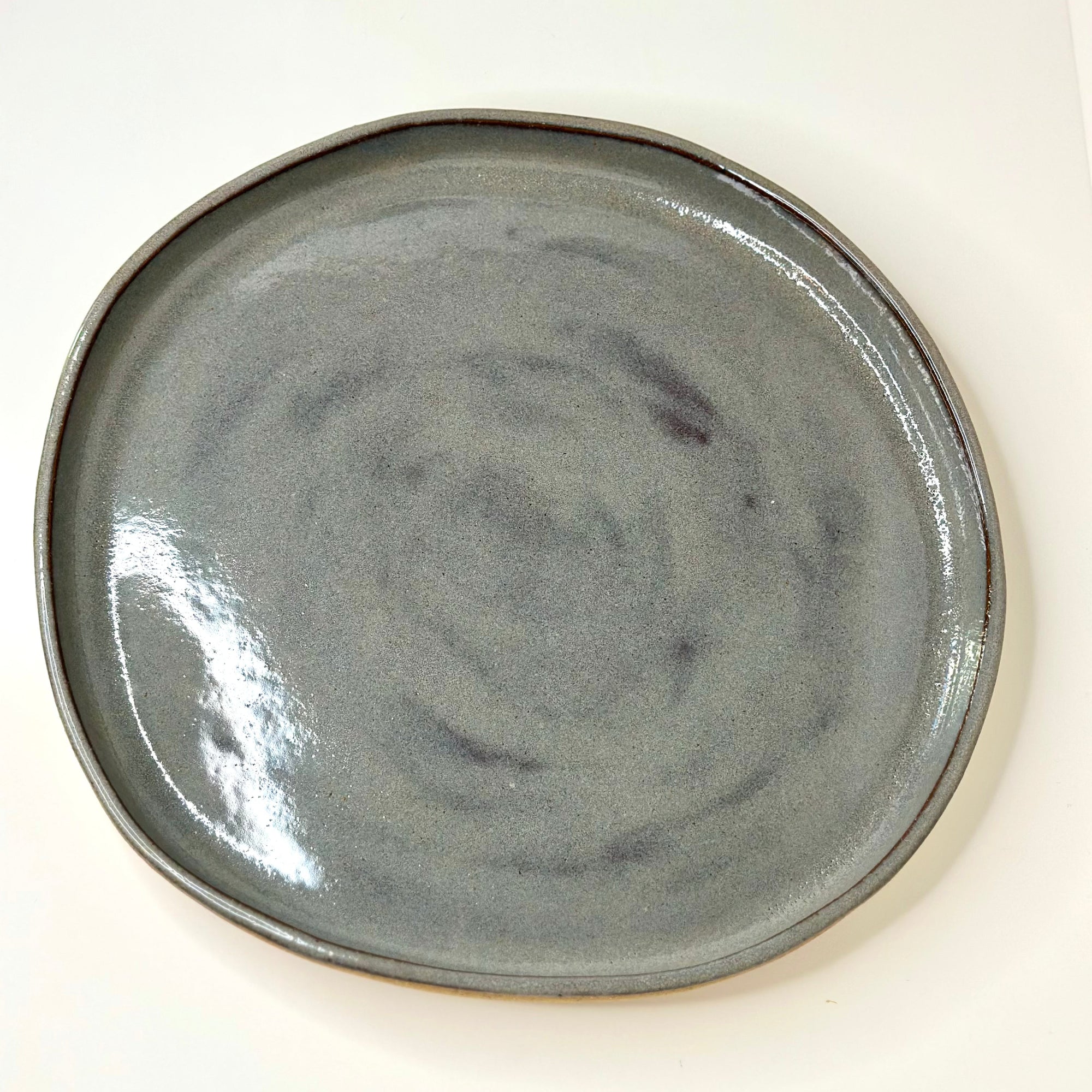 Gray ceramic plate on a white background