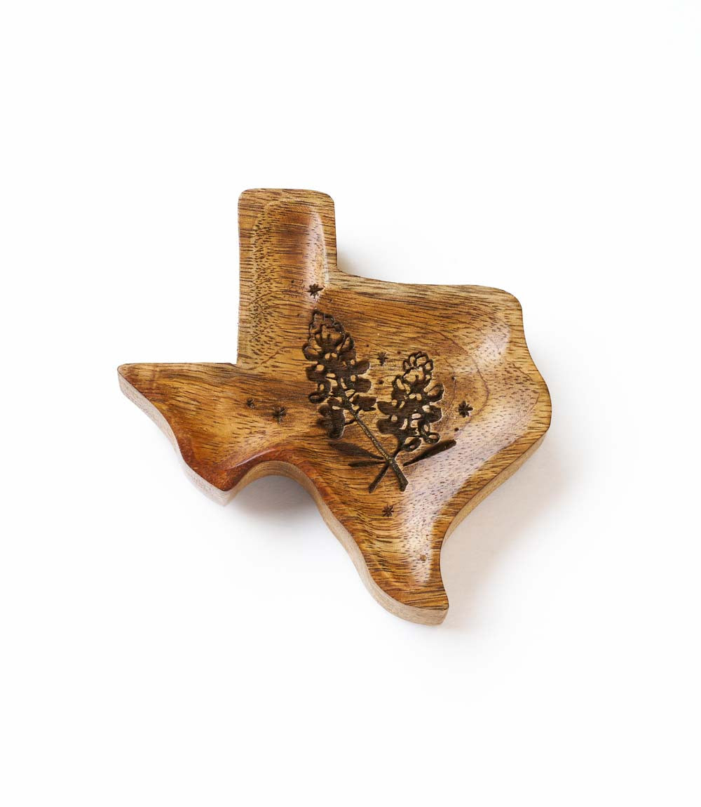 Wooden Texas-shaped cutting board with engraved design on a white background