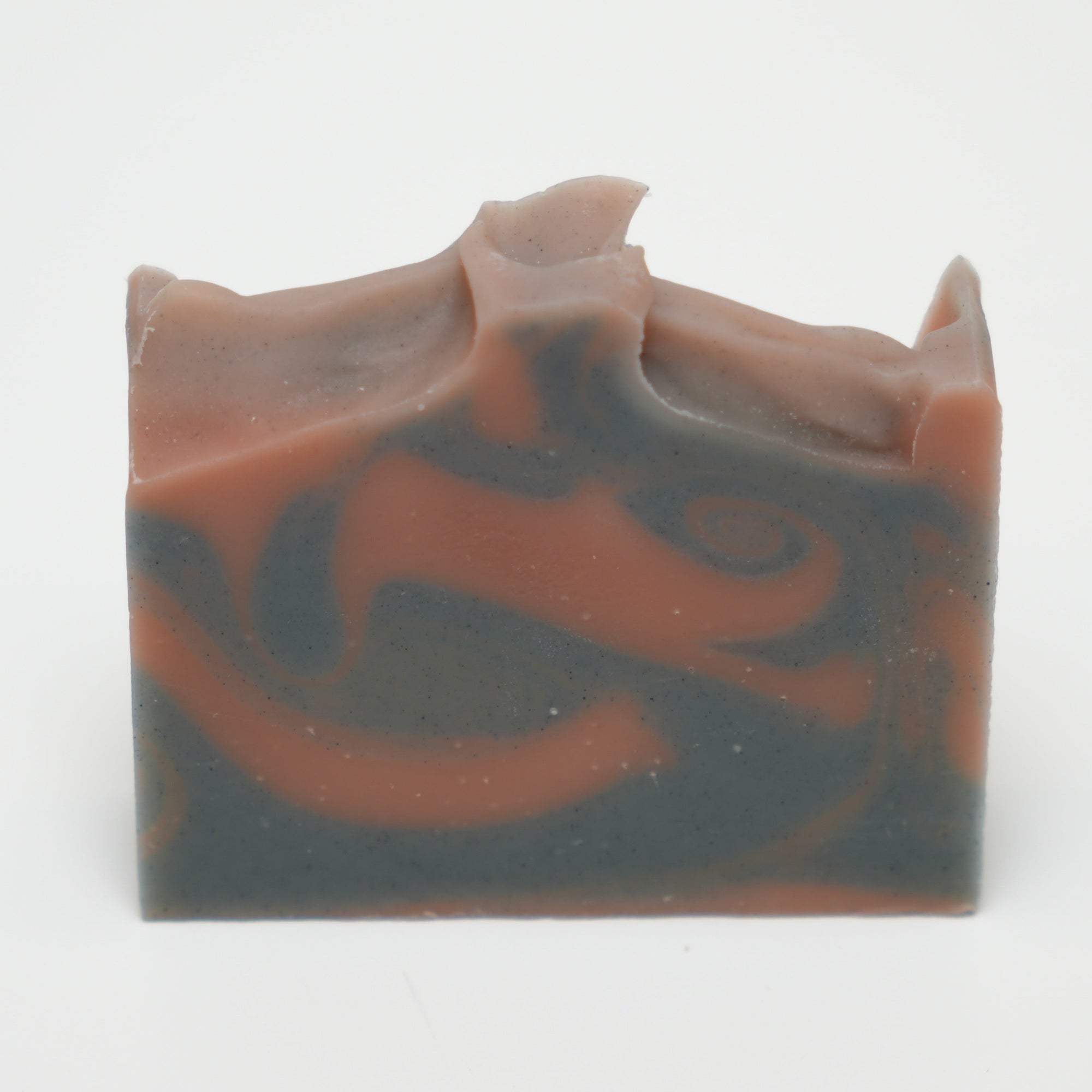 Bar of soap with brown and gray swirls on a white background