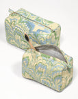 Two patterned toiletry bags on a white background