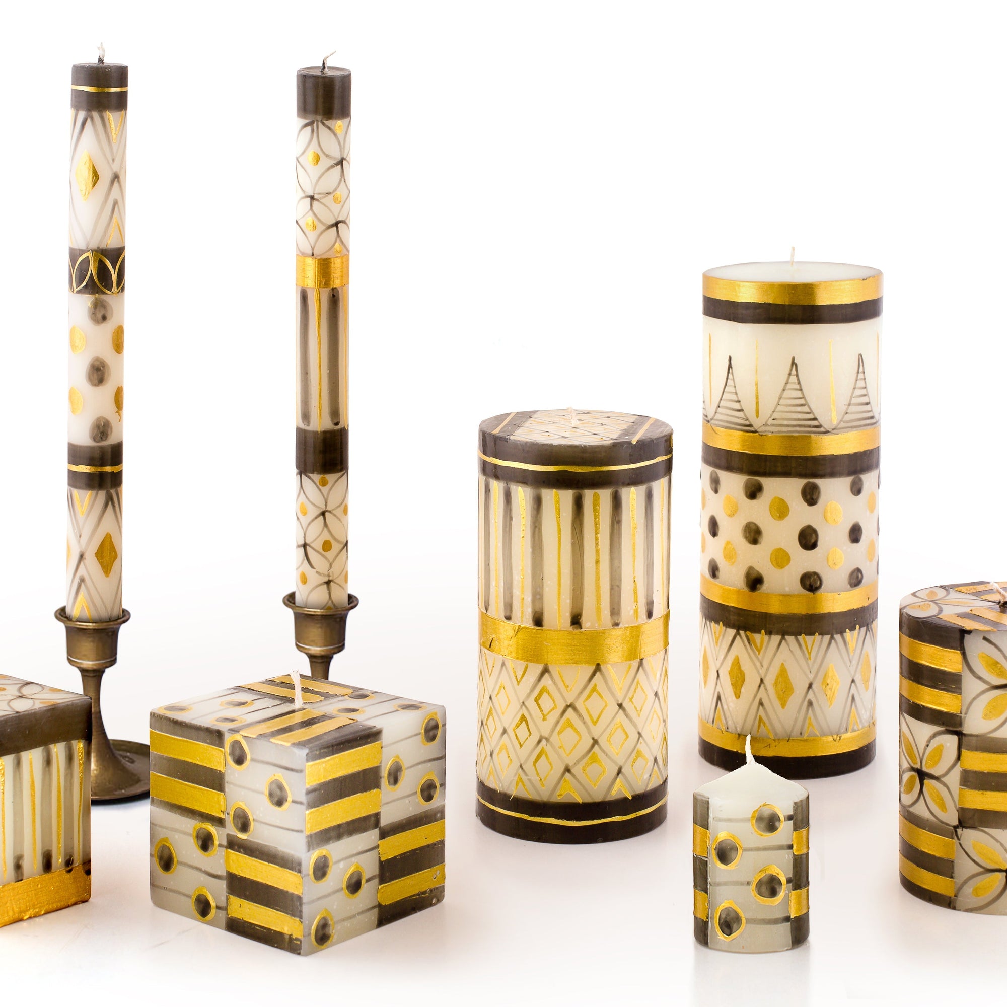 Decorative candles and containers with geometric patterns on a white background