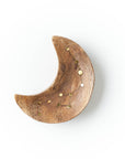 Wooden crescent moon-shaped trinket dish with gold accents on a white background