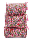 Set of three pink floral travel bags stacked on a white background