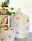 Woven baskets with colorful triangle patterns on a wooden floor.