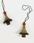 Two striped ceramic bell christmas tree ornaments on strings against a white background