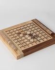 Wooden reversi game board with pieces on a white background