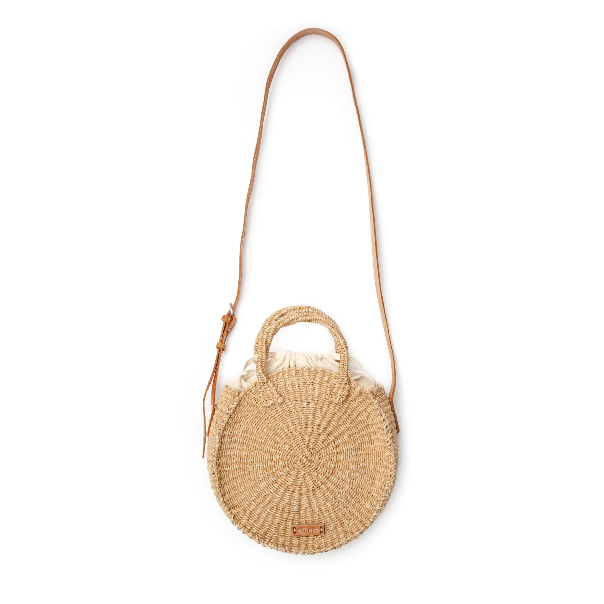 Woven handbag with a strap on a white background