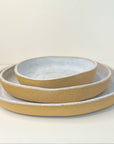 Set of three ceramic bowls with a textured finish on a white background
