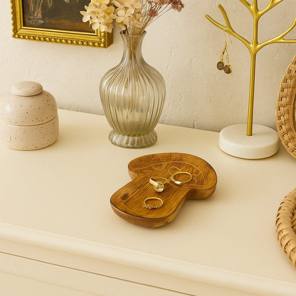 Decorative mushroom design trinket dish on a dresser including a vase, jewelry display, and a framed painting.
