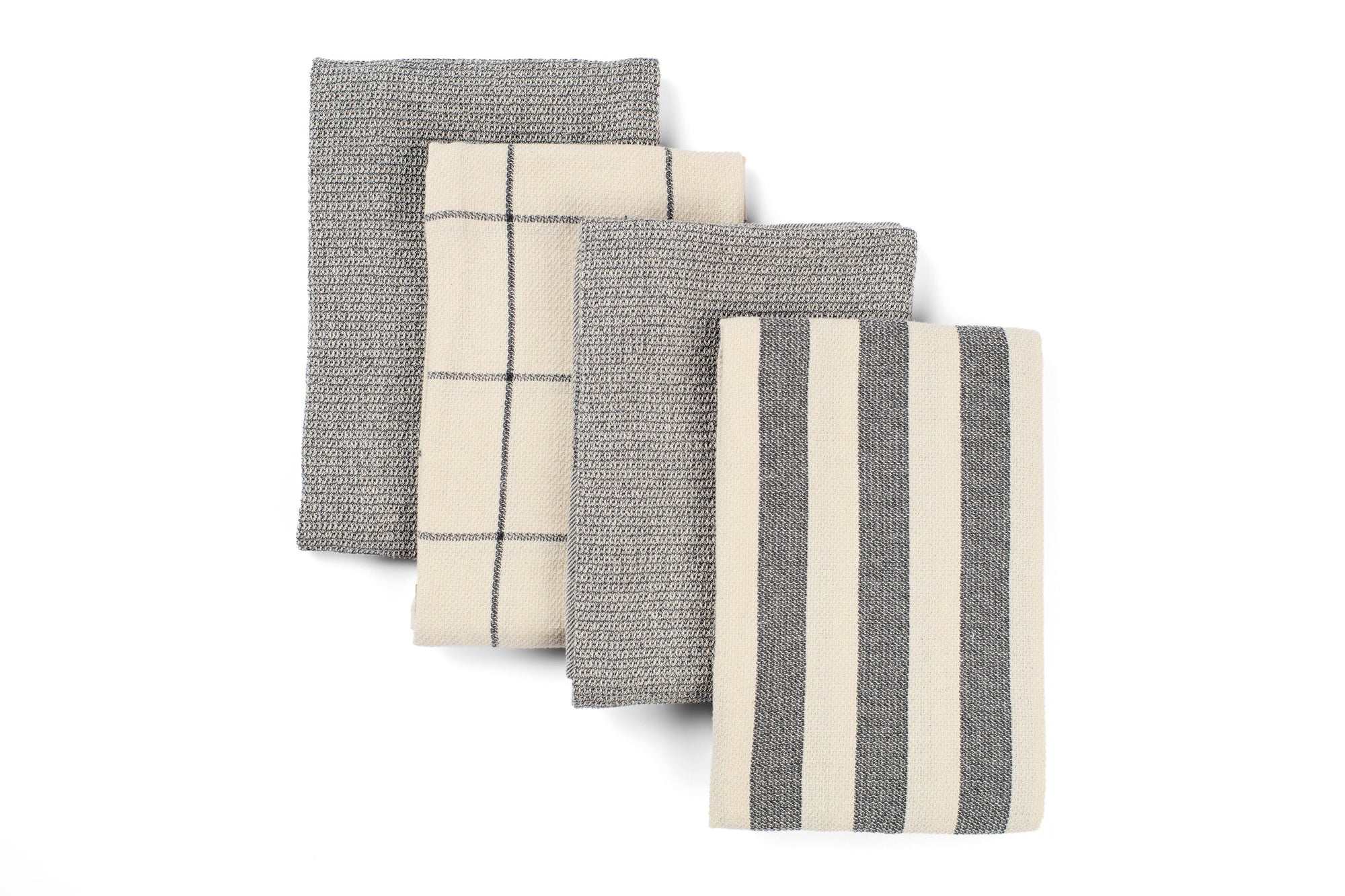 Set of four gray and white patterned towels on a white background