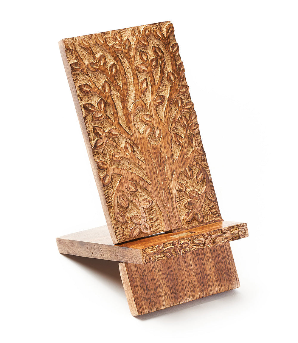 Wooden phone stand with tree of life design on a white background