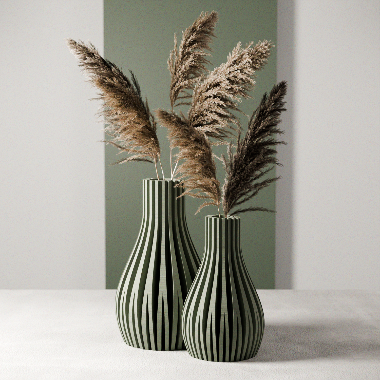 Two black and white striped vases with dried pampas grass against a neutral background