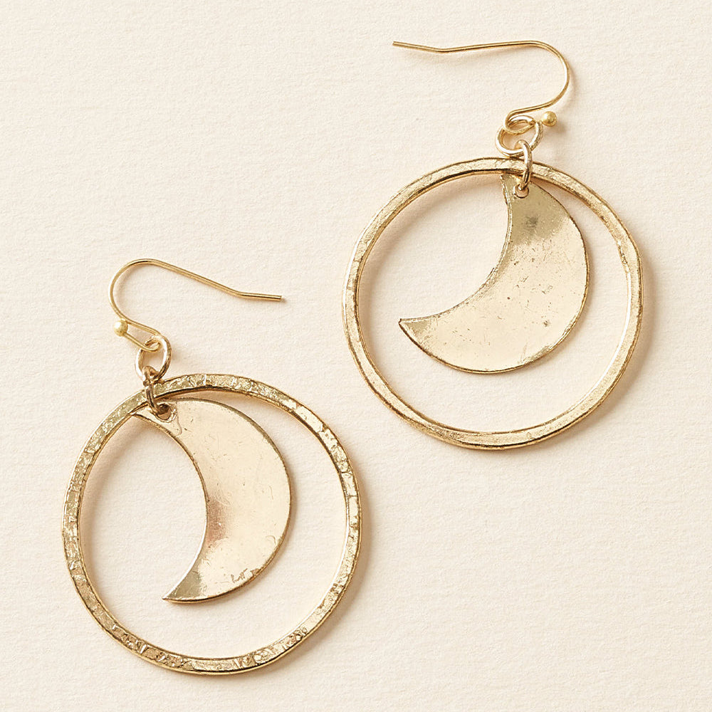 Gold hoop earrings with crescent moon designs on a beige background