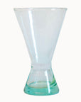 Clear cocktail glass with a cone shaped base on a white background