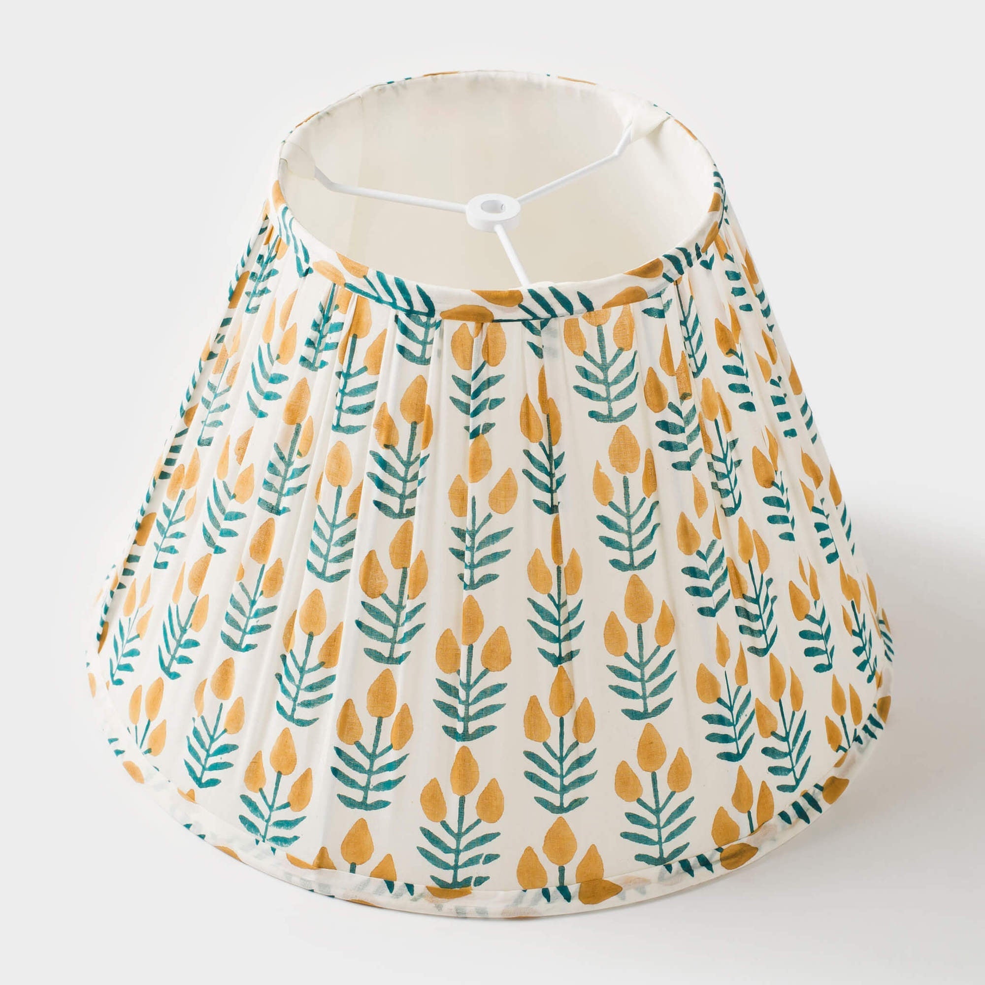 Lampshade with yellow and green leaf pattern on a white background