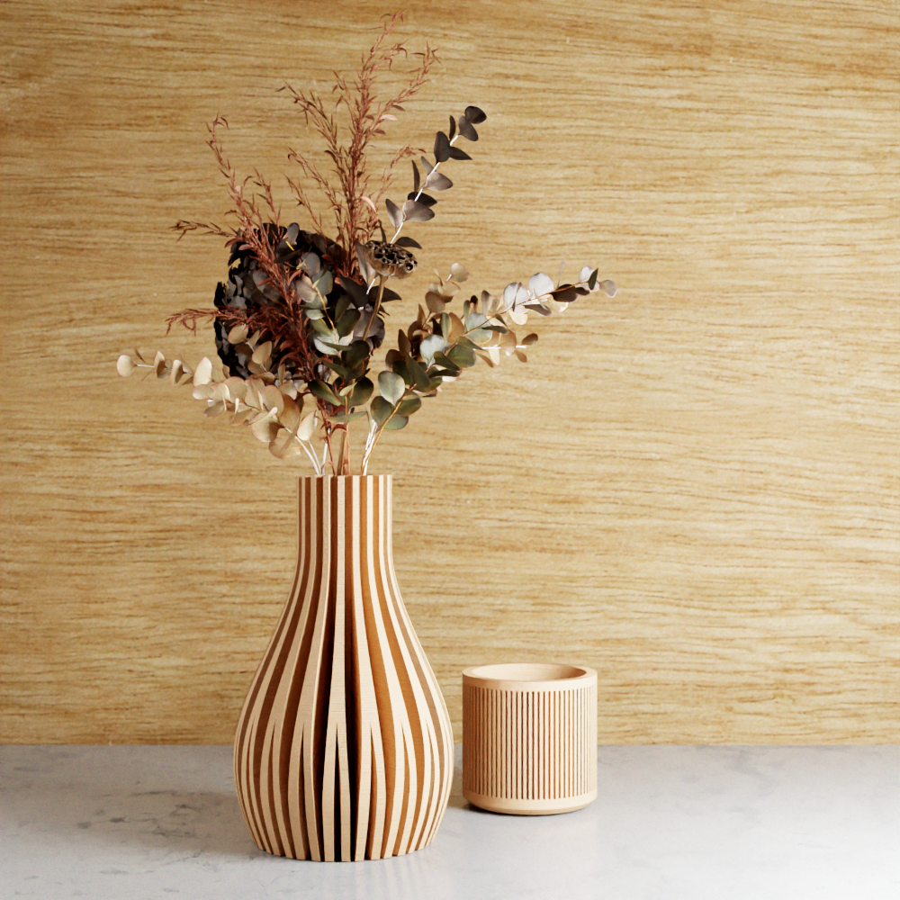 Beige striped vases with dried pampas grass against a neutral background