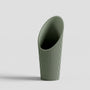 Green soil scoop on a light gray background